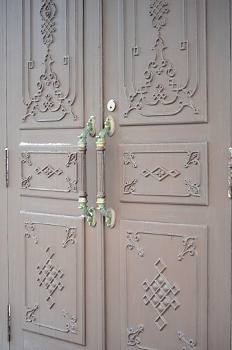 antique door with decorative ornaments with locks and handles