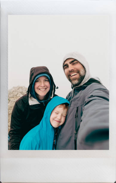 Happy Family Taking an Instant Selfie at Sulfur Skyline, Jasper, Alberta, Canada stock photo