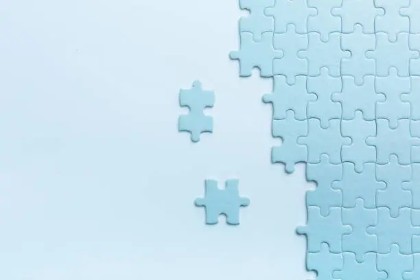 Blue puzzles on both sides with separate elements. High quality photo