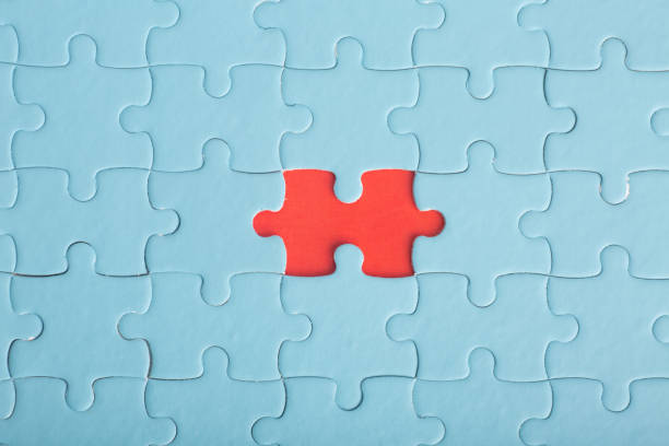 istock Red puzzle on blue puzzles. The concept of loneliness, unity, confrontation. 1449124138