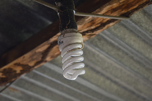 Klang, Malaysia: December 14, 2022- A LED light bulb under a house roof.