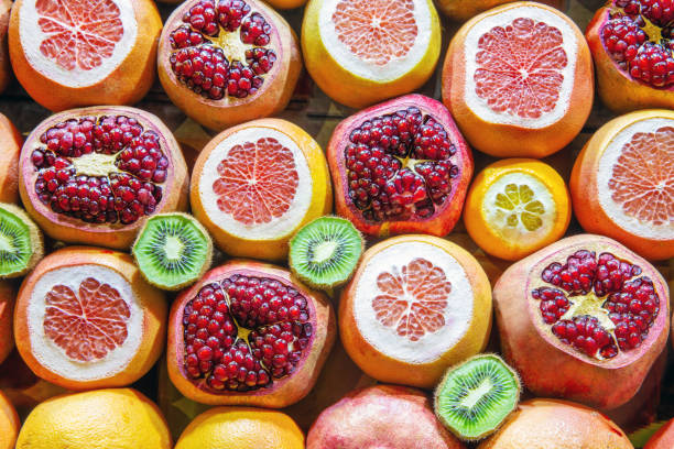 sliced fruit as an advertisement for a place where they make fresh juices pomegranate, kiwi, oranges,  grapefruites, (citrus fruites)