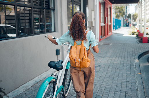 Woman, bike or city travel with eco friendly, carbon footprint environment sustainability or future green energy transport. Fashion student, cool and model walking with bicycle on Brazilian sidewalk