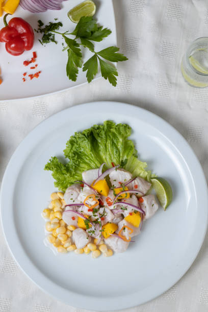 istock Top view of Ceviche, typical fish-based dish of Peruvian cuisine, and ingredients. 1449128013