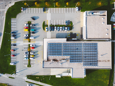 Aerial view of discount retailer chain with a large parking lot somewhere in the countryside of Slovenia.
