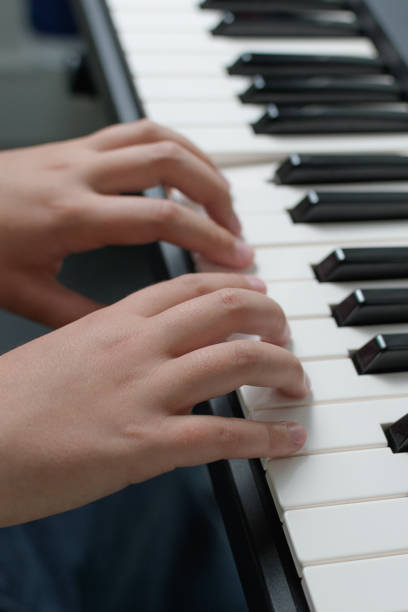 istock Music lessons. Two hands piano playing exercises. Keyboard close-up. 1449131976