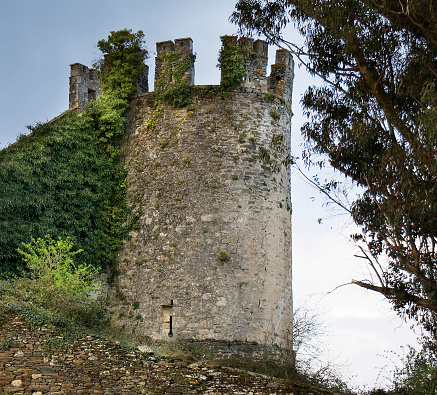 Ancient medieval defending tower, partially ruined and covered with ivy. Sarria village, camino de Santiago, camino francés, Lugo province, Galicia, Spain.