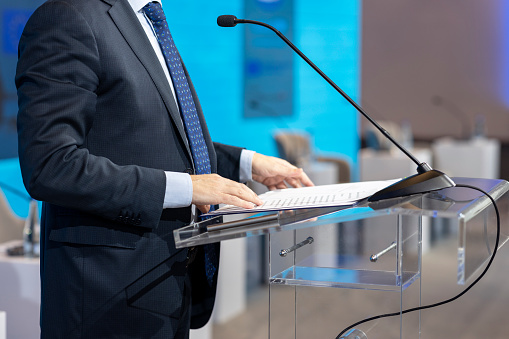 Speaker at business conference, presentation or news event