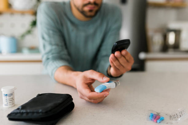 istock Close up of man using lancet on finger for checking blood sugar level by Glucose meter, Healthcare and Medical, diabetes, glycemia concept 1449139211