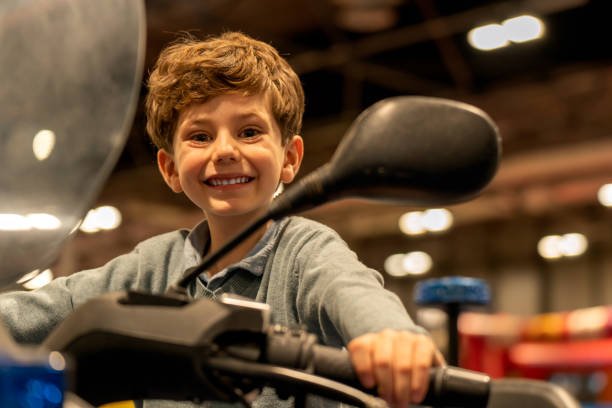 istock Cheerful boy on vehicle in mall 1449140058