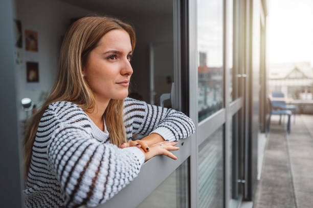 istock Woman studying getting some fresh air looking out the window taking a break from studying 1449140134