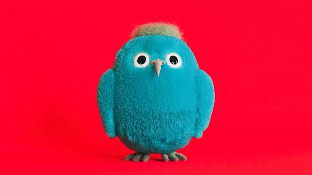 istock Blue fluffy bird mascot, surprised furry creature on a red background, 3d render 1449141010