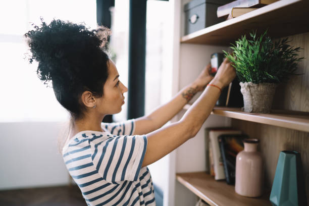 istock Thoughtful woman choosing book at home 1449142419