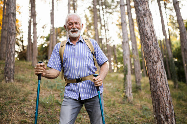 istock Senior man using hiking poles on a hike 1449142539