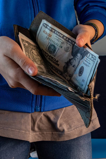 istock Hands showing a wallet full of dollars. 1449144131