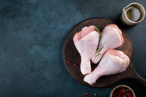 istock Raw uncooked chicken legs. meat with ingredients for cooking 1449144389