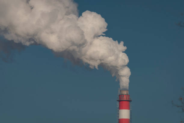 istock Color chimney with white smoke and blue background 1449144811