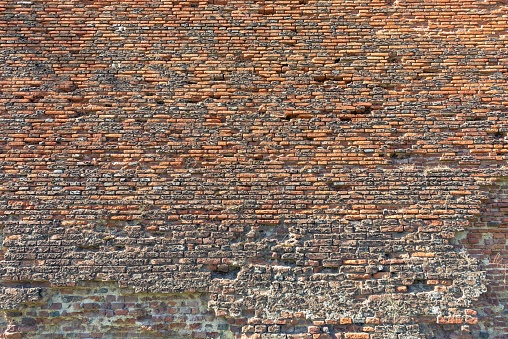 A brick wall of an old damaged building, can be used for wallpaper