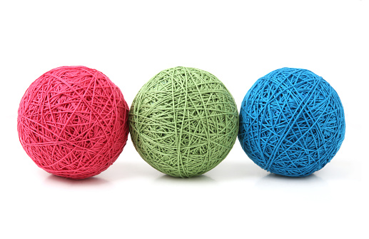 Knitting balls of cotton string of different colors.