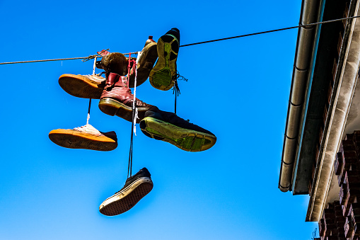 shoes over a cable in the air - photo