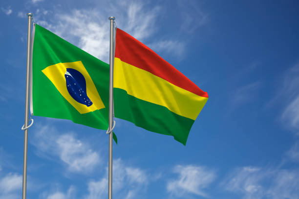 Federative Republic of Brazil and Plurinational State of Bolivia Flags Over Blue Sky Background. 3D Illustration stock photo