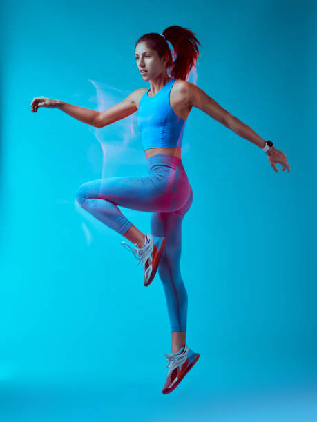 istock A fit sportswoman jumping and doing exercises. Long exposure capture movement. 1449149721