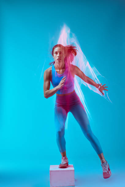 istock A sportswoman doing box jumps and exercising. Long exposure capture movement. 1449149756