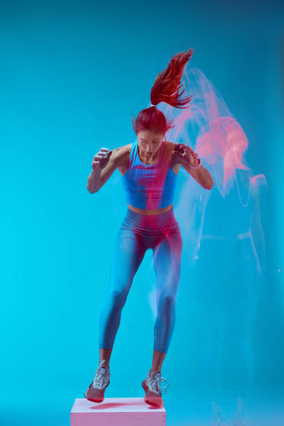 istock A sportswoman doing box jumps and exercising. Long exposure capture movement. 1449149787