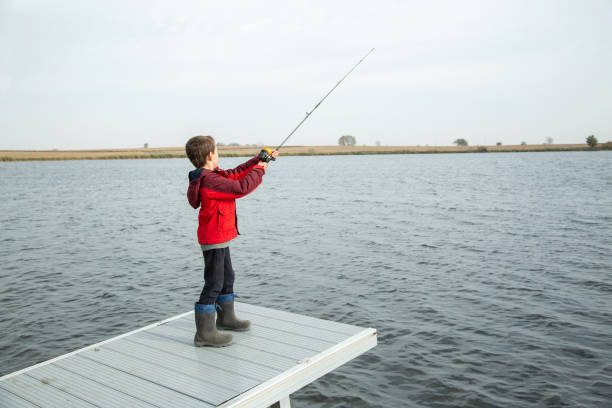 istock Young Boy Fishing From End of Dock 1449151403