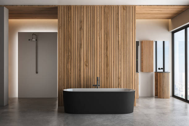 istock Modern bathroom interior with concrete floor, black white bathtub and double basin, shower, wooden wall, plant and city view from windows. Minimalist bathroom with modern furniture. 3D rendering 1449151710