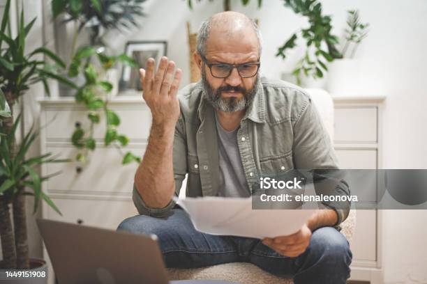 Mature Man Working From Home Stock Photo - Download Image Now - Paycheck, Sadness, 50-54 Years