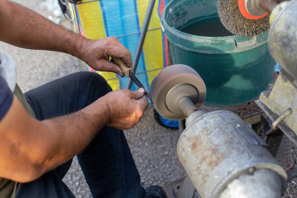 istock Man sharpening a knife in the market 1449155551