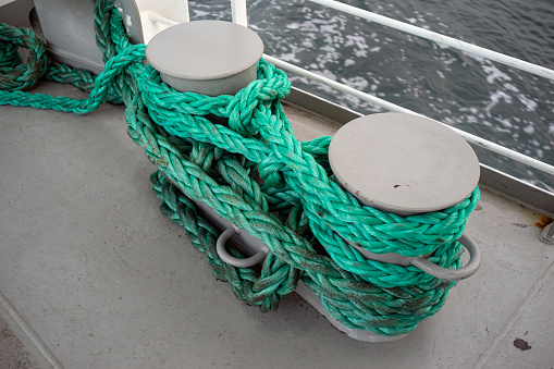 Old fashioned harbor marina sail boat ropes. Yachting details and objects concept.