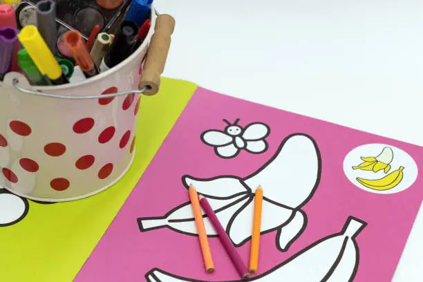Childrens coloring book with colored pencils. Child development concept.