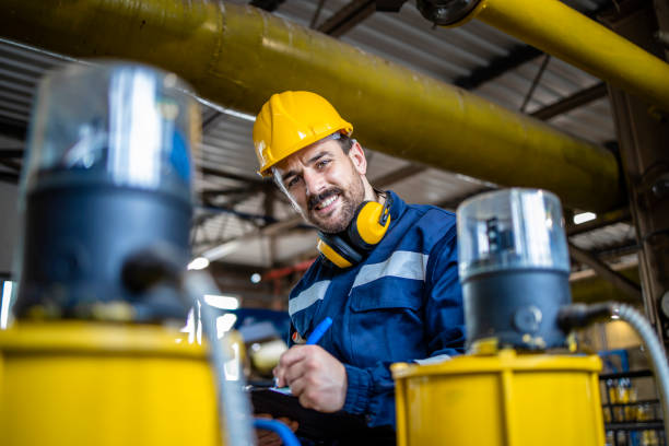 istock Gas pipe inspector doing quality control inside refinery storage room. 1449160172