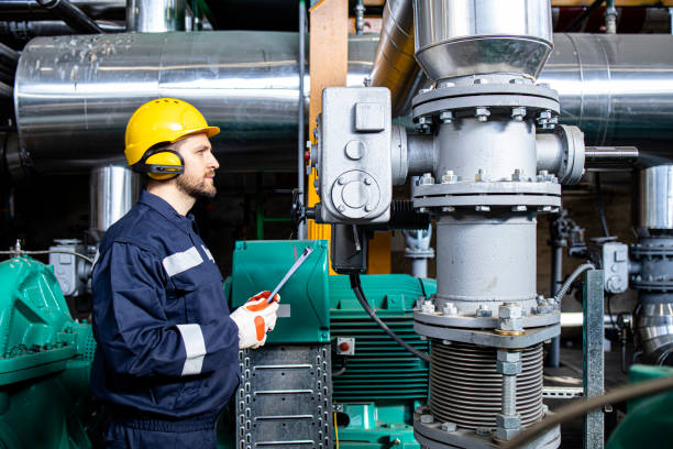 istock Factory serviceman checking generator engines and production in power plant. 1449161109