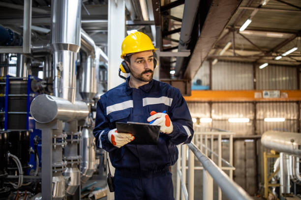 istock Night shift worker foreman walking through heating plant and controlling process of heating. 1449161254