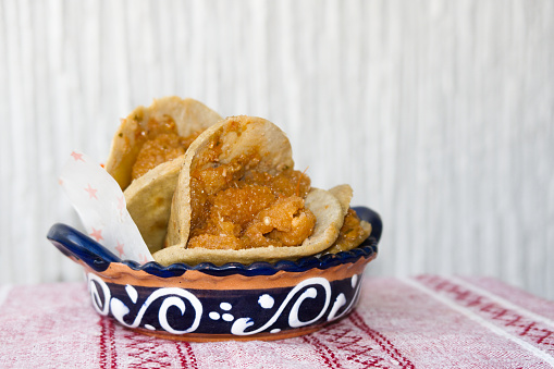 A Mexican gorditas de migajas with pork rinds and chile