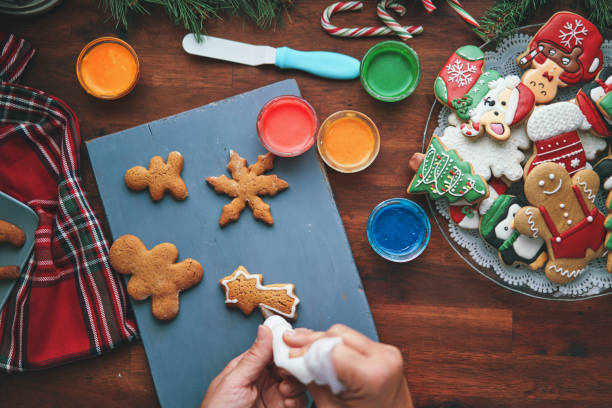 istock Decorating Gingerbread Christmas Cookies with Icing 1449167460