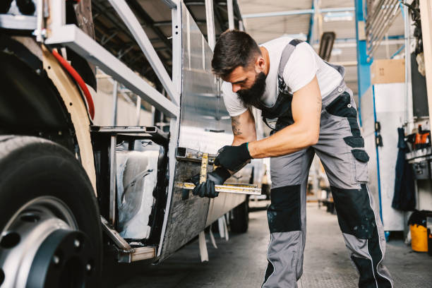 A heavy industry worker building a bus at workshop. A metal worker building a bus at workshop. industrial music stock pictures, royalty-free photos & images