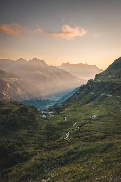 istock Scenic view of a mountain range covered in green color under the sun rays 1449170046