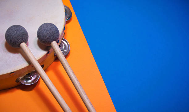 Music percussion template background, with a hand drum tambourine and drumsticks.