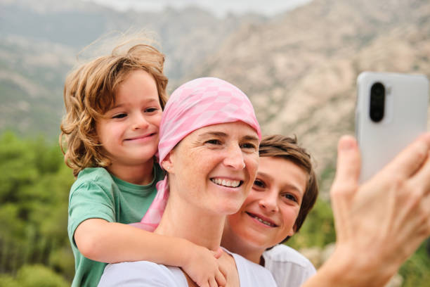 Self-portrait of a woman with cancer and her children stock photo