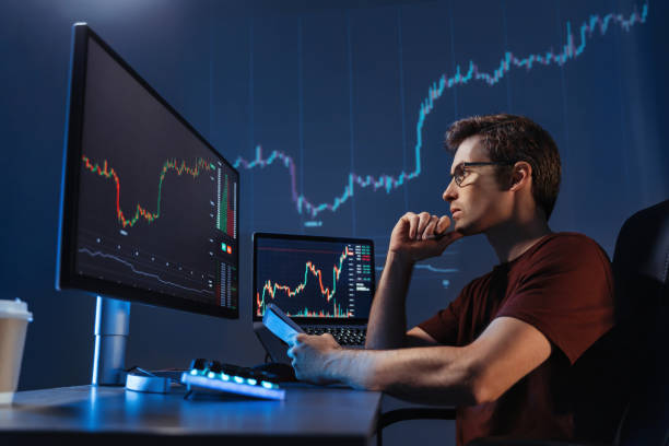 istock Crypto trader sitting in front of computers, making professional analysis of candlestick chart 1449176160