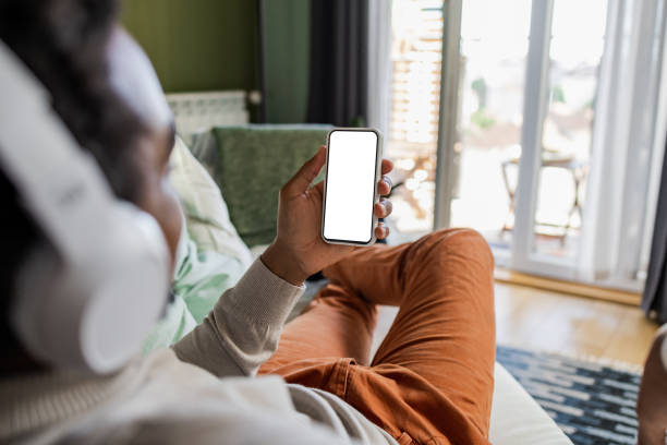 istock African-American young man chilling on the sofa 1449177410