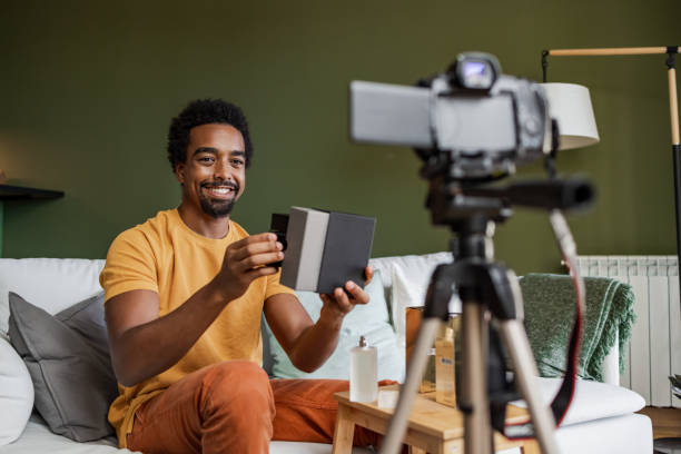 istock Young man shooting a video at home 1449178362
