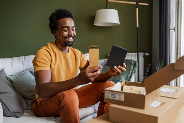 istock Young man opening online delivery packages 1449178805