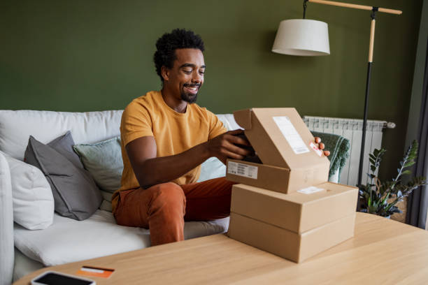 istock Smiling man opening a delivery box 1449178946