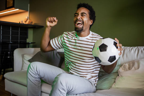 istock Soccer fan celebrating during match 1449179603