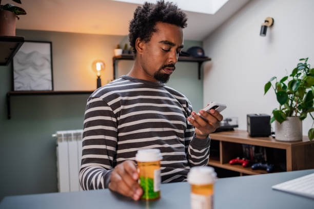 istock Young Black man reading about medicine online 1449180521